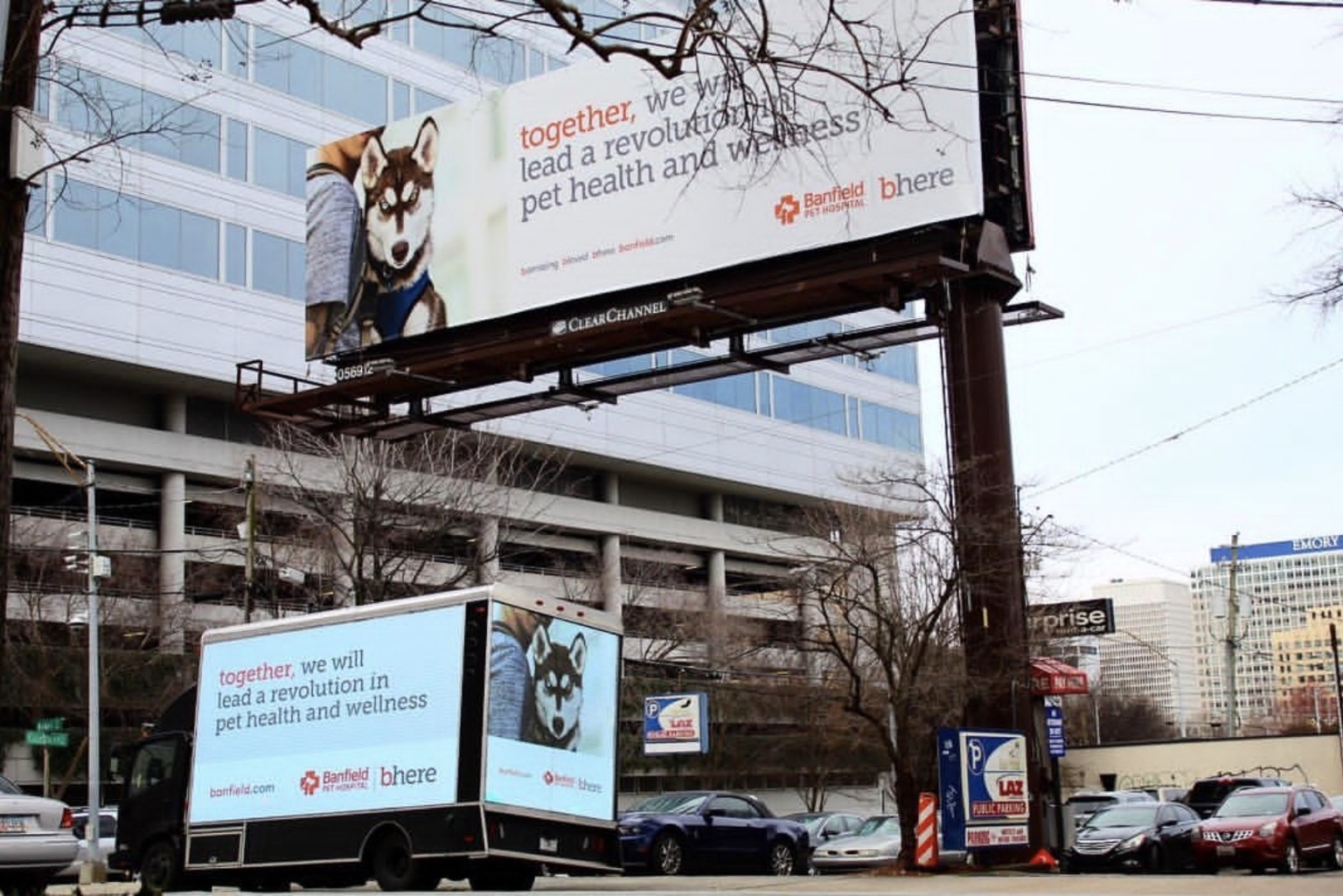 Banfield Pet Hospital creative on a digital mobile billboard and a fixed billboard