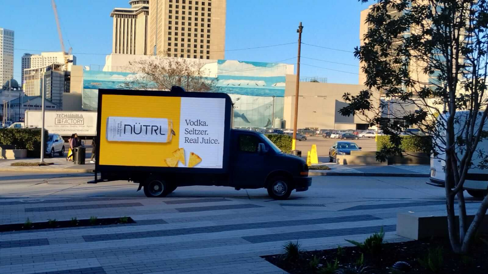 Authentic digital mobile billboard truck operating near a convention and event district