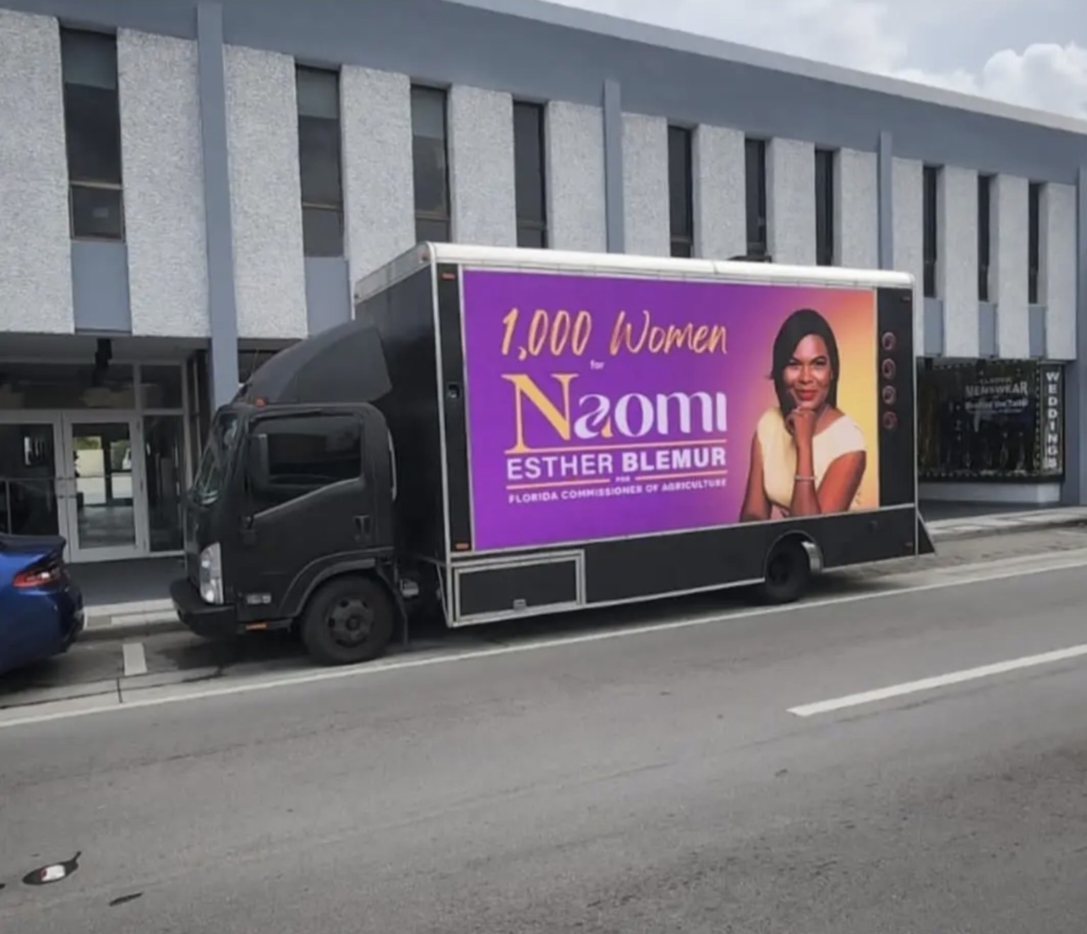 Digital mobile billboard truck displaying Naomi Esther Blemur campaign creative